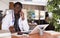 Highly qualified african american doctor conducts a patient consultation on a mobile phone