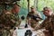 A highly trained military unit strategizes and organizes a tactical mission while studying a military map during a