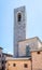 Hight stone tower with bell in ancient town San Gimignano
