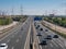Highway A-1 towards Burgos with six entry and exit lanes and service roads surrounded by electricity towers and a beautiful blue s