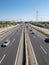 Highway A-1 towards Burgos with six entry and exit lanes and service roads surrounded by electricity towers and a beautiful blue s