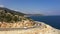 A highway along the Mediterranean sea in Turkey. Aerial view of the coastline road. Bus and car travel along the shore