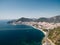 Highway along the sea on the coast of Budva at the foot of the mountains. Montenegro. Drone
