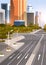 Highway asphalt road with marking arrows traffic signs city skyline modern skyscrapers cityscape sunrise background flat