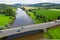 Highway  autobahn with moving cars over the Weser river against the background of mountains and fields