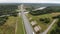 Highway bridge river forest. modern straight road track. M11. Aerial drone view