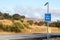 A highway call box along a rural roadside serves to help drivers in trouble