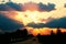 Highway with cars traveling on the sunset. Horizon line with the sun and storm clouds. Journeys. Selective focus