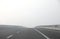 highway with dense dangerous fog without cars during a days in w