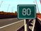 Highway detail in diminishing perspective and 80 km distance or milage sign