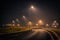 Highway exit during a foggy night with street lights