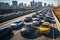 A highway filled with lots of traffic next to tall buildings in a big city