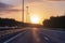 Highway in the glare of sunlight, illuminated by the sun. Urban landscape