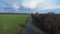 Highway in green field colorful rainbow aerial view