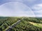 Highway in green forest, colorful rainbow, city. Netherlands