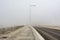 Highway and the light pole under thick fog at the Abu Dhabi, the biggest and most populated city of United Arab Emirates