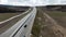 Highway outside the city, panoramic view from above with driving cars. Shot. Straight highway stretching along fields