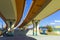Highway, overpasses and colored concrete columns.