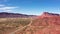 Highway passes through picturesque canyon with red sandstone cliffs aerial view