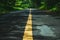 Highway road with trees and leading yellow painted lines in mountain landscapes after rain in northern Thailand.