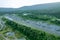 Highway through rocky mountains, tunnel entrance, road through forest.