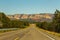 A highway runs along the red-sandstone.