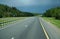 the highway stretching away into the distance summer trees