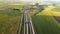 Highway with traffic in rural scenery. Suburban highway with cars and trucks. Travel and transportation. Aerial view