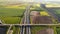 Highway with traffic in rural scenery. Suburban highway with cars and trucks. Travel and transportation. Aerial view