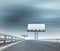 Highway with two billboards afar with blurred sky