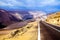 Highway through white dry barren salt valley Cordillera de la Sal Salt mountains with blurred horizon