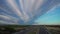 Highway with windmills and vineyards at dusk