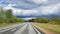 Highway in the woods and dark low clouds a few minutes before the rain