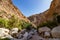 Hike through narrow valley of Wadi Shab in Tiwi near Mascat in Oman