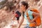Hike travel Asian hiker woman carrying heavy backpack tired on outdoor trek in Grand Canyon trail walking up the mountain. Active