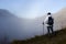 Hiker above the clouds