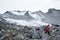 Hiker above Snowbird Glacier in Hatcher Pass area of Alaska, sum