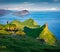 Hiker admiring of amazing mountain lanscape, Alaberg cliffs, Faroe Islands, Denmark, Europe. Stunning morning view of Mykines isla