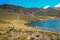 A hiker against the background of Lake Alice in Mount Kenya National Park, Kenya