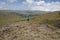 A hiker against a mountain background at the La Satima Dragons Teeth in the Aberdares, Kenya