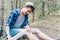 Hiker applying a bandage in a forest during the hike