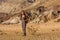 A hiker in the Artist`s Palette landmark place in Death Valley National Park, Geology, sand