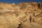 A hiker in the Artist`s Palette landmark place in Death Valley National Park, Geology, sand