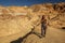 A hiker in the Artist`s Palette landmark place in Death Valley National Park, Geology, sand