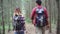 Hiker Asia backpacker couple on hiking adventure feeling freedom walking in forest.