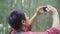 Hiker Asia backpacker man using smartphone for take a picture while on hiking adventure walking in forest.