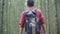 Hiker Asian backpacker man on hiking adventure feeling freedom walking in forest.
