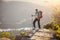 Hiker with baby standing on cliff