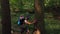 Hiker with backpack climbing on Adventure Trip in Natural Woods in Hiking. Man cling on tree trunk