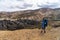 Hiker with backpack looking at Landmannalaugar Valley. Iceland. Colorful mountains on the Laugavegur hiking trail. The